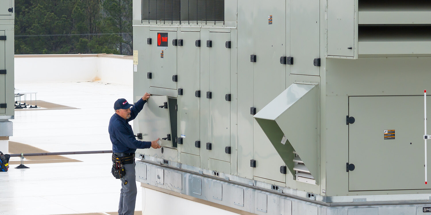 HVAC Technician Servicing Rooftop Air Handling Unit