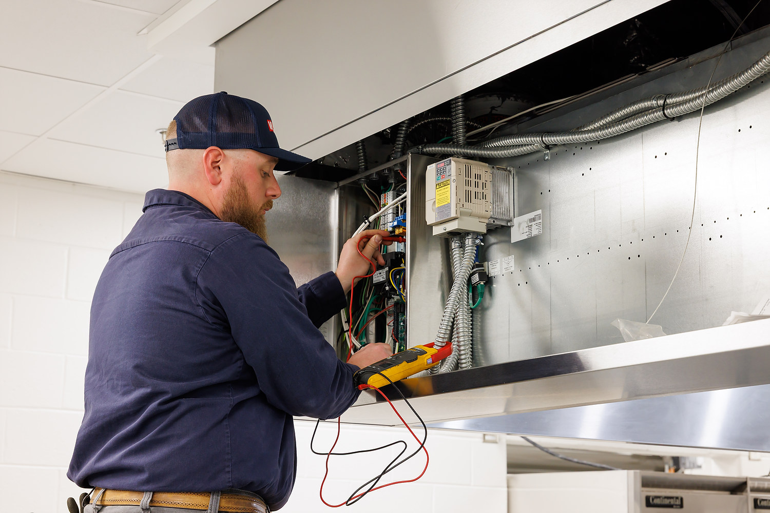 HVAC Technician Testing Electrical Components