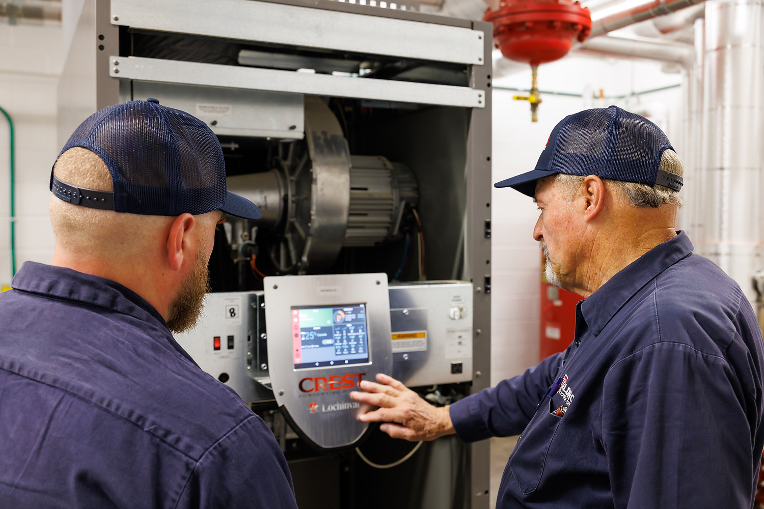 HVAC Technicians Inspecting Boiler Control Panel